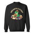 Unearth A Story Summer Reading 2026 Dinosaur Book Floral Sweatshirt Unearth A Story Summer Reading 2026 Dinosaur Book Floral Sweatshirt