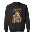 Unearth a Story Triceratops Dinosaur Reading Books Dino Sweatshirt