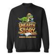 Women's Unearth a Story Dinosaur Reading Books Summer 2026 Sweatshirt Women's Unearth a Story Dinosaur Reading Books Summer 2026 Sweatshirt