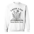 A Book A Day Keeps Reality Away Floral Reader Sweatshirt