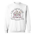 A New Chapter Retired 2026 Begins Retirement Wildflower Book Sweatshirt A New Chapter Retired 2026 Begins Retirement Wildflower Book Sweatshirt