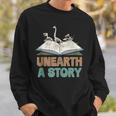 Unearth A Story Skeleton Dinosaur Book Summer Reading 2026 Sweatshirt Gifts for Him Unearth A Story Skeleton Dinosaur Book Summer Reading 2026 Sweatshirt Gifts for Him