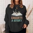 Unearth A Story Skeleton Dinosaur Book Summer Reading 2026 Sweatshirt Gifts for Her Unearth A Story Skeleton Dinosaur Book Summer Reading 2026 Sweatshirt Gifts for Her