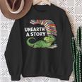 Summer Reading 2026 Unearth a Story Theme Dinosaur Book Nerd Sweatshirt Gifts for Old Women Summer Reading 2026 Unearth a Story Theme Dinosaur Book Nerd Sweatshirt Gifts for Old Women