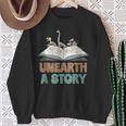 Unearth A Story Skeleton Dinosaur Book Summer Reading 2026 Sweatshirt Gifts for Old Women Unearth A Story Skeleton Dinosaur Book Summer Reading 2026 Sweatshirt Gifts for Old Women
