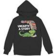 Summer Reading 2026 Unearth a Story Theme Dinosaur Book Nerd Unisex Hoodie Summer Reading 2026 Unearth a Story Theme Dinosaur Book Nerd Unisex Hoodie
