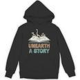 Unearth A Story Skeleton Dinosaur Book Summer Reading 2026 Unisex Hoodie Unearth A Story Skeleton Dinosaur Book Summer Reading 2026 Unisex Hoodie