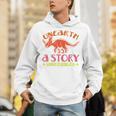 Unearth a Story Summer Reading 2026 Triceratops Dino Book Premium Tri-Blend Unisex Hoodie Unearth a Story Summer Reading 2026 Triceratops Dino Book Premium Tri-Blend Unisex Hoodie