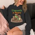 Women's Unearth a Story Summer 2026 Dinosaur Reading Books Dino Unisex Hoodie Women's Unearth a Story Summer 2026 Dinosaur Reading Books Dino Unisex Hoodie