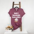Busy Raising Ballers Baseball Mom Groovy Mother Day Women's Heather T-Shirt Heather Maroon Busy Raising Ballers Baseball Mom Groovy Mother Day Women's Heather T-Shirt Heather Maroon
