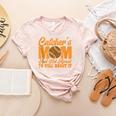 Catcher's Mom And Not Afraid Leopard Baseball Mom Women's Heather T-Shirt Heather Peach Catcher's Mom And Not Afraid Leopard Baseball Mom Women's Heather T-Shirt Heather Peach