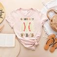 Women Kids Baseball Game Day Vibes Smile Baseball Mom Women's Heather T-Shirt Heather Peach Women Kids Baseball Game Day Vibes Smile Baseball Mom Women's Heather T-Shirt Heather Peach