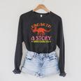 Unearth a Story Summer Reading 2026 Triceratops Dino Book Raglan Sleeve Sweatshirt Dark Grey Heather Unearth a Story Summer Reading 2026 Triceratops Dino Book Raglan Sleeve Sweatshirt Dark Grey Heather