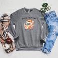 BOOKTROVERT Cute Cat With Tea Cozy Sweater And Book Raglan Sleeve Sweatshirt Deep Heather BOOKTROVERT Cute Cat With Tea Cozy Sweater And Book Raglan Sleeve Sweatshirt Deep Heather