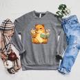 Capybara Reading a Book With Bubble Tea Raglan Sleeve Sweatshirt Deep Heather