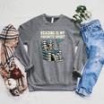 Football Skeleton Reading On Book Stack Raglan Sleeve Sweatshirt Deep Heather