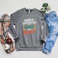 Pet Lover Joke Easily Distracted By Dogs And Books Men Raglan Sleeve Sweatshirt Deep Heather