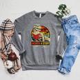 Unearth a Story Dinosaur Reading Book Dino T Rex Summer 2026 Raglan Sleeve Sweatshirt Deep Heather