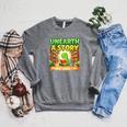 Unearth A Story Dinosaur Summer Reading 2026 Books Raglan Sleeve Sweatshirt Deep Heather