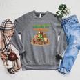 Unearth a Story Summer 2026 Dinosaur Reading Books Dino Raglan Sleeve Sweatshirt Deep Heather