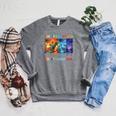 Women's Summer Reading 2026 Unearth A Story Dinosaur Books Raglan Sleeve Sweatshirt Deep Heather