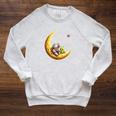 Astronaut Reading Book To Alien Moon Space Astronomy Raglan Sleeve Sweatshirt Heather Mustard