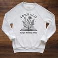 A Book A Day Keeps Reality Away Floral Reader Raglan Sleeve Sweatshirt Heather Mustard A Book A Day Keeps Reality Away Floral Reader Raglan Sleeve Sweatshirt Heather Mustard