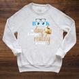 A Book A Day Keeps Reality Away Keep Your Day Dream Raglan Sleeve Sweatshirt Heather Mustard