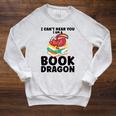 I Can't Hear You I Am a Book Dragon Reading Book Raglan Sleeve Sweatshirt Heather Mustard I Can't Hear You I Am a Book Dragon Reading Book Raglan Sleeve Sweatshirt Heather Mustard