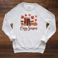 Cozy Season Autumn Leaves Books Pumpkins Fall Halloween Raglan Sleeve Sweatshirt Heather Mustard Cozy Season Autumn Leaves Books Pumpkins Fall Halloween Raglan Sleeve Sweatshirt Heather Mustard