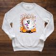 Ghost Reading Book On Swing Halloween Autumn Art Raglan Sleeve Sweatshirt Heather Mustard
