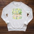 Groovy It's Good Luck To Read St Patrick's Day Book Lucky Raglan Sleeve Sweatshirt Heather Mustard