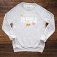 Most Likely To Read a Book By The Pool Raglan Sleeve Sweatshirt Heather Mustard