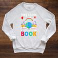 Take A Look It's In A Book Reading Vintage Retro Rainbow Raglan Sleeve Sweatshirt Heather Mustard