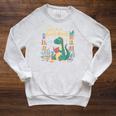 Lost In a Good Book Cute Reading Dinosaur Illustration Raglan Sleeve Sweatshirt Heather Mustard