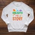 Summer Reading 2026 Dinosaurs Book Lover Unearth A Story Raglan Sleeve Sweatshirt Heather Mustard Summer Reading 2026 Dinosaurs Book Lover Unearth A Story Raglan Sleeve Sweatshirt Heather Mustard