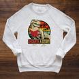 Unearth a Story Dinosaur Reading Book Dino T Rex Summer 2026 Raglan Sleeve Sweatshirt Heather Mustard