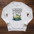 Unearth a Story Frog Reading a Book Summer 2026 Premium Tri-Blend Raglan Sleeve Sweatshirt Heather Mustard Unearth a Story Frog Reading a Book Summer 2026 Premium Tri-Blend Raglan Sleeve Sweatshirt Heather Mustard