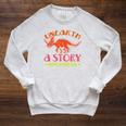 Unearth a Story Summer Reading 2026 Triceratops Dino Book Premium Tri-Blend Raglan Sleeve Sweatshirt Heather Mustard Unearth a Story Summer Reading 2026 Triceratops Dino Book Premium Tri-Blend Raglan Sleeve Sweatshirt Heather Mustard