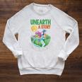 Unearth A Story Summer Reading Program 2026 Animals Book Raglan Sleeve Sweatshirt Heather Mustard Unearth A Story Summer Reading Program 2026 Animals Book Raglan Sleeve Sweatshirt Heather Mustard