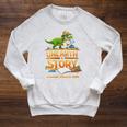 Women's Unearth a Story Dinosaur Reading Books Summer 2026 Raglan Sleeve Sweatshirt Heather Mustard