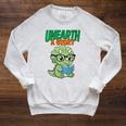 Women's Unearth a Story Summer Reading 2026 Triceratops Dino Book Raglan Sleeve Sweatshirt Heather Mustard Women's Unearth a Story Summer Reading 2026 Triceratops Dino Book Raglan Sleeve Sweatshirt Heather Mustard