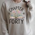 1986 Chapter Forty 40th Birthday Wildflower Book 40 Year Old Raglan Sleeve Sweatshirt Heather Forest 1986 Chapter Forty 40th Birthday Wildflower Book 40 Year Old Raglan Sleeve Sweatshirt Heather Forest