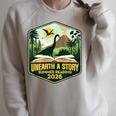 2026 Summer Reading Unearth a Story Teachers Students Book Raglan Sleeve Sweatshirt Heather Forest