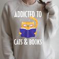 Addicted To Cats And Books Orange Tabby Cat Men Women Kids Raglan Sleeve Sweatshirt Heather Forest