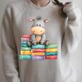 Adorable Donkey With Heart Sitting On Colorful Book Stack Raglan Sleeve Sweatshirt Heather Forest