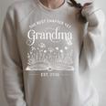 The Best Chapter Yet Grandma Est 2026 Book Lover Floral Raglan Sleeve Sweatshirt Heather Forest