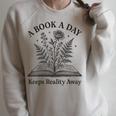 A Book A Day Keeps Reality Away Floral Reader Raglan Sleeve Sweatshirt Heather Forest A Book A Day Keeps Reality Away Floral Reader Raglan Sleeve Sweatshirt Heather Forest