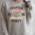 Chapter Forty 1986 40th Birthday Wildflower Book Lover Raglan Sleeve Sweatshirt Heather Forest