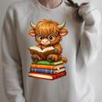 Cute Highland Cow With Glasses Reading Books Raglan Sleeve Sweatshirt Heather Forest Cute Highland Cow With Glasses Reading Books Raglan Sleeve Sweatshirt Heather Forest